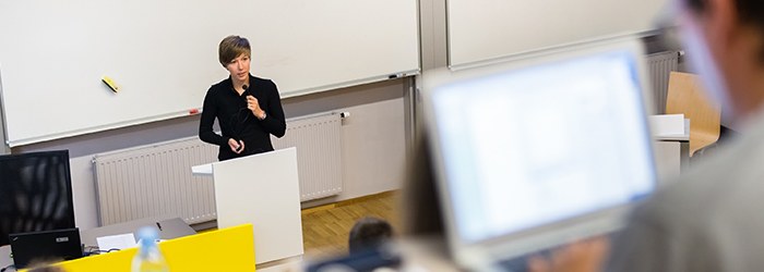 Photo: Woman at a desk in a lecture hall